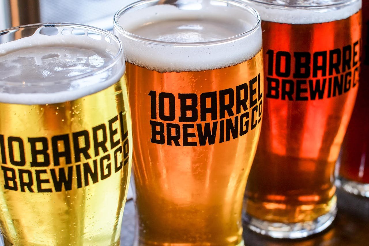 A flight of three beers including a golden pale ale, showing the range of colors from pale to amber