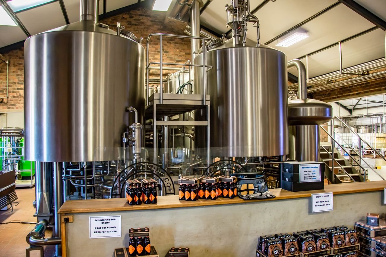 Cases of bottled beer stacked in a brewery, ready for distribution